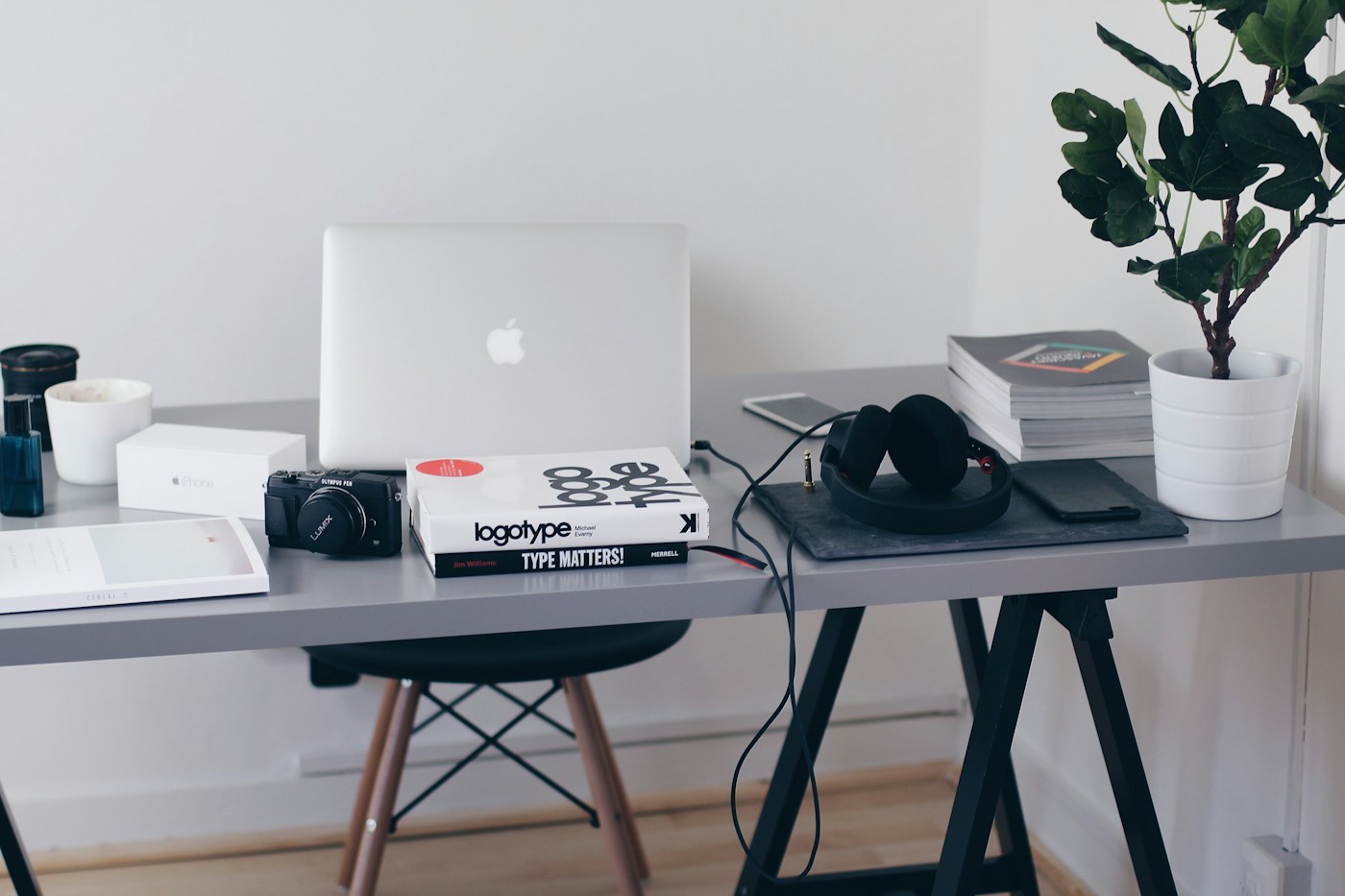 A calm workspace with a laptop and design books